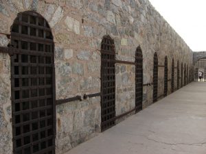 Stone cellblocks and iron gates at Yuma Territorial Prison.
